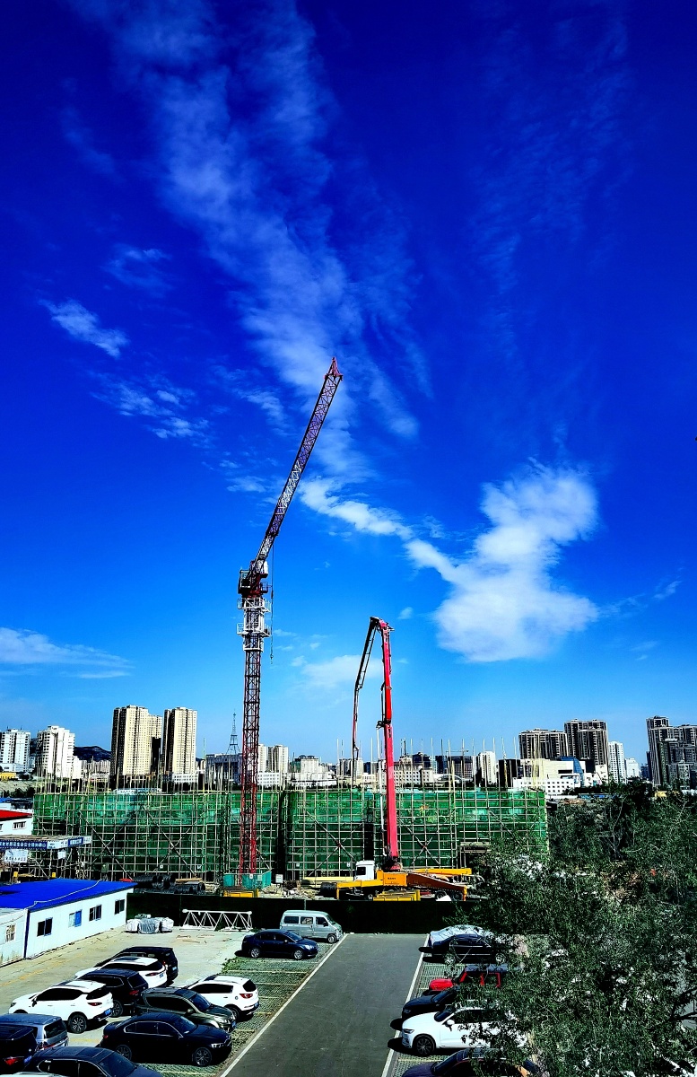 Construction site with blue skies and white clouds